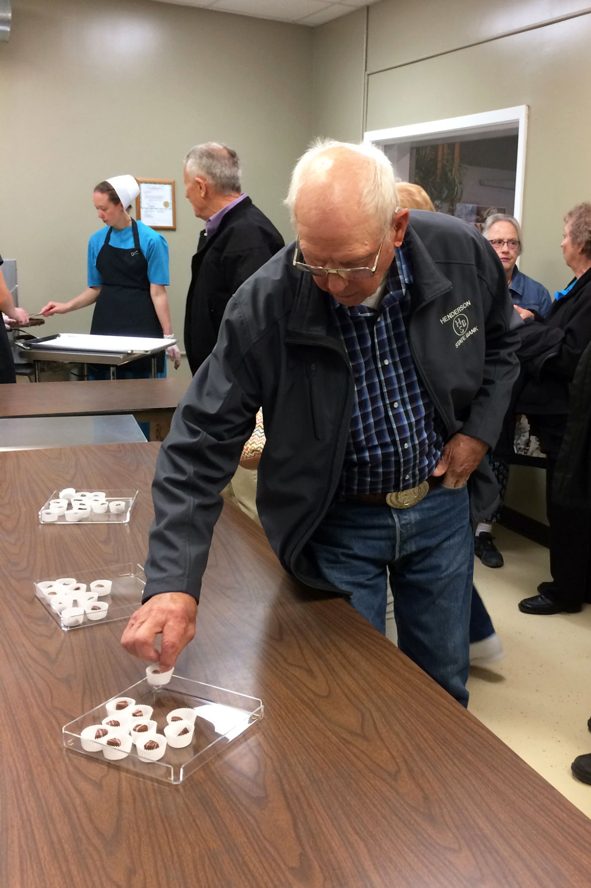 069 Arvid Janzen reaches for a sample at Kalona Chocolates.JPG
